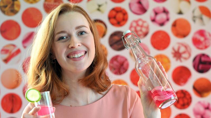 Kunden naschen trotz Krisen gern Model Christin hält auf der Internationalen Süßwarenmesse ein Glas Wodka in der Hand, das mit Sweet Shots-Bonbonmasse versetzt wurde.
