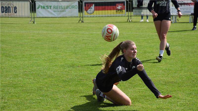 Faustballerin Monja Schlichting vom MTV Wangersen hechtet zum Ball und auf den Rasen.
