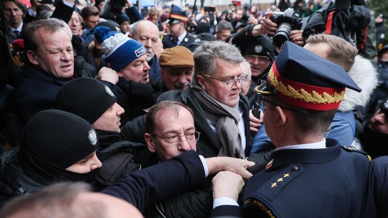PiS-Politiker liefern sich Gerangel mit Parlamentswache Müssen draußen bleiben: Mariusz Kaminski (M.) und Maciej Wasik (M., hinten) vor dem polnischen Parlamentsgebäude.
