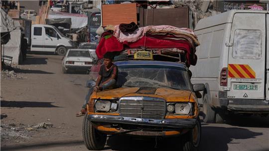 Palästinenser fliehen aus dem nördlichen Gazastreifen mit einem uralten Mercedes, auf den sie ihre Habseligkeiten geladen haben. 