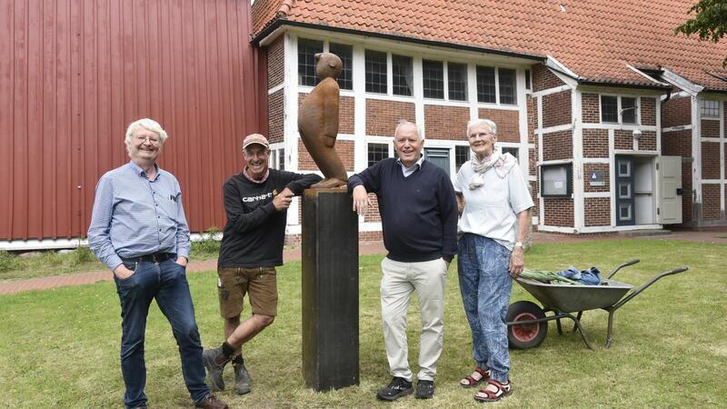 Pastor Uwe Junge, Künstler Jonas Kötz sowie die Kirchenvorstände Heinz-Joachim Mohr und Anke Frese mit der neuen Figur vor der Kirche.