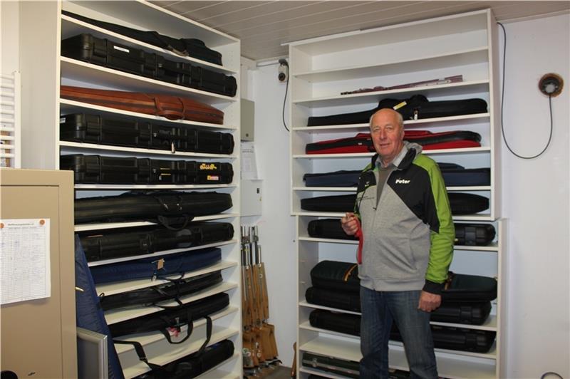 Peter Palm öffnet die Tür zur Waffenkammer . In den weißen Regalen liegen die Taschen mit den Luftgewehren. Foto: Scholz