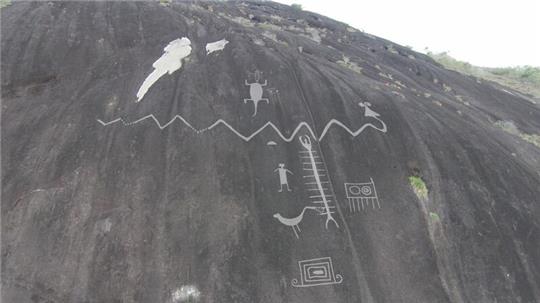 Petroglyphen sind in einen Fels graviert.