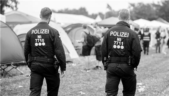 Polizisten gehen über den Zeltplatz des Deichbrand Festivals. Die Ermittler haben ein Fremdverschulden ausgeschlossen. (Symbolbild)