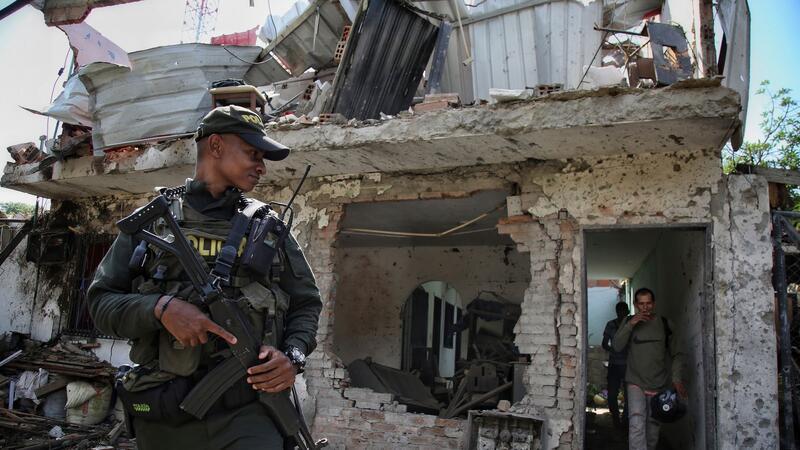 Waffenstillstand in Kolumbien vereinbart Polizisten stehen nach der Explosion einer Autobombe Wache im kolumbianischen Jamundi.