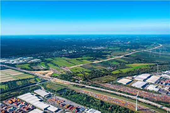 Rechts und links der Autobahn A7 stehen Container. Aus dem Alten Land nähert sich die A26 per Sanddamm dem geplanten Autobahndreieck in Moorburg. Foto: Martin Elsen