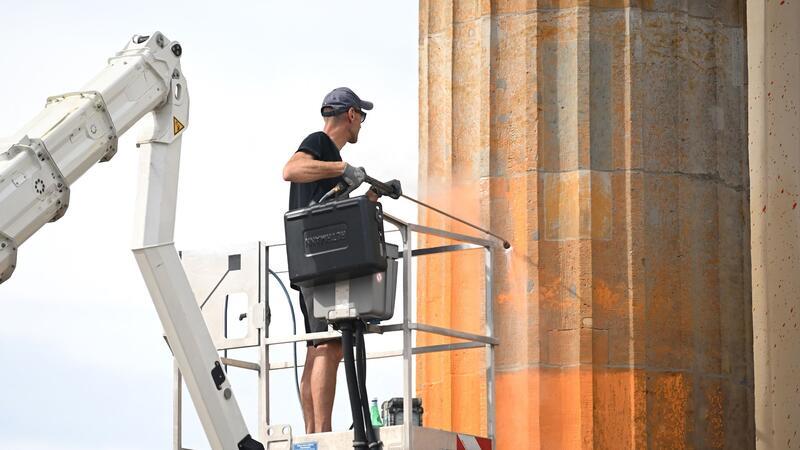 Farbattacke auf Brandenburger Tor: Klage gegen Aktivisten Reinigungsarbeiten nach dem Farbanschlag: Mitglieder der Letzten Generation hatten am 17. September 2023 das symbolträchtige Wahrzeichen besprüht.