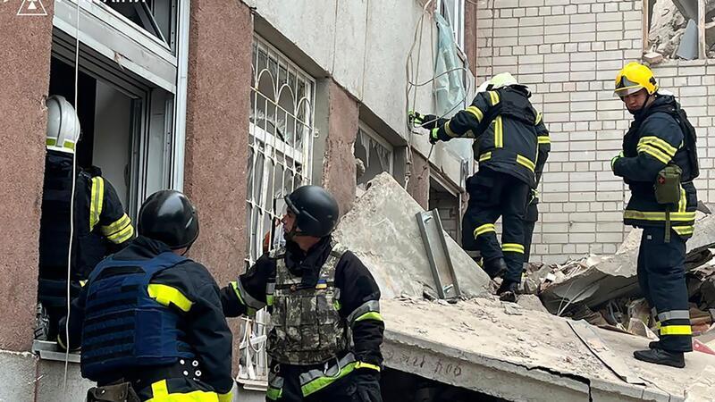 Rettungskräfte an einem zerstörten Gebäude in Tschernihiw.