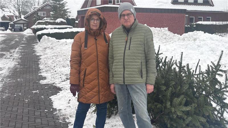 Ria und Ulrich Bargsten zwischen geräumtem Eschenweg und einigen der liegen gebliebenen Tannenbäume. Rechts sieht man, wie viel Schnee die Anwohner von der Straße räumten.