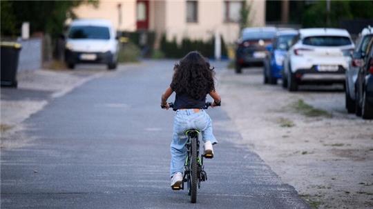 Sara fährt mit einem Fahrrad auf einer Straße in Berlin-Spandau. Die 12-jährige Gymnasiastin hat die häufigste Art von Kinderrheuma (juvenile idiopathische Arthritis).