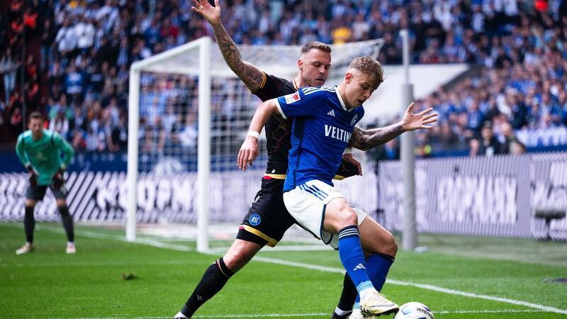 Schalkes Keke Topp (r) und Karlsruhes Marcel Franke kämpfen um den Ball.