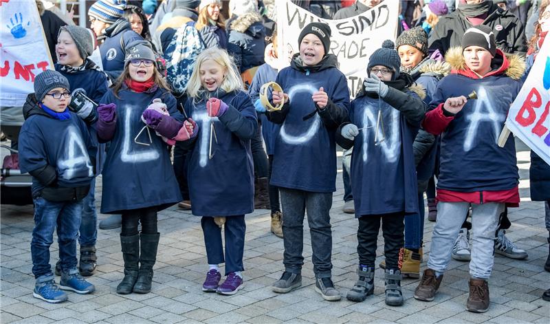 Schüler mit der Aufschrift "Altona" auf ihren Jacken demonstrieren auf dem Hamburger Gänsemarkt für den Erhalt von 21 katholischen Schulen. Foto Axel Heimken/dpa