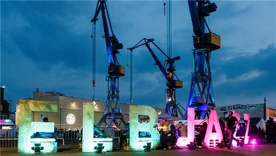 Sitzbänke, deren Rückenlehnen das Wort "Elbjazz" bilden, stehen auf dem Gelände des Elbjazz-Festivals. Foto: Markus Scholz/dpa