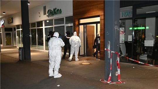 Spezialisten der Spurensicherung betreten das Wohn- und Geschäftshaus in der Bahnhofstraße 27-31.