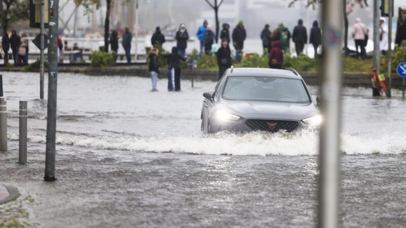 Große Schäden nach Ostseeflut – Fähren fahren wieder Ein Auto fährt durch die Wassermassen in der Innenstadt. Ein mächtiger Sturm drückt das Ostseewasser ans Land und sorgt für Überschwemmungen in Schleswig-Holstein. In Flensburg könnte es die höchste Sturmflut seit 100 Jahren werden. Foto: Frank Molter/dpa +++ dpa-Bildfunk +++