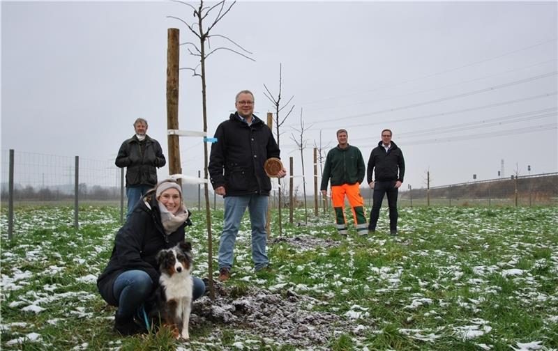 Svenja Johannsen freut sich für Kiwi über die neue Hundewiese in Horneburg an der Autobahn (rechts). „Trees For Bees“-Gründer Thomas Bösch (vorn) sowie Gemeindedirektor Torsten Milter, Bauhof-Chef Rainer Rambow und Sponsor Thomas Rackow (vo