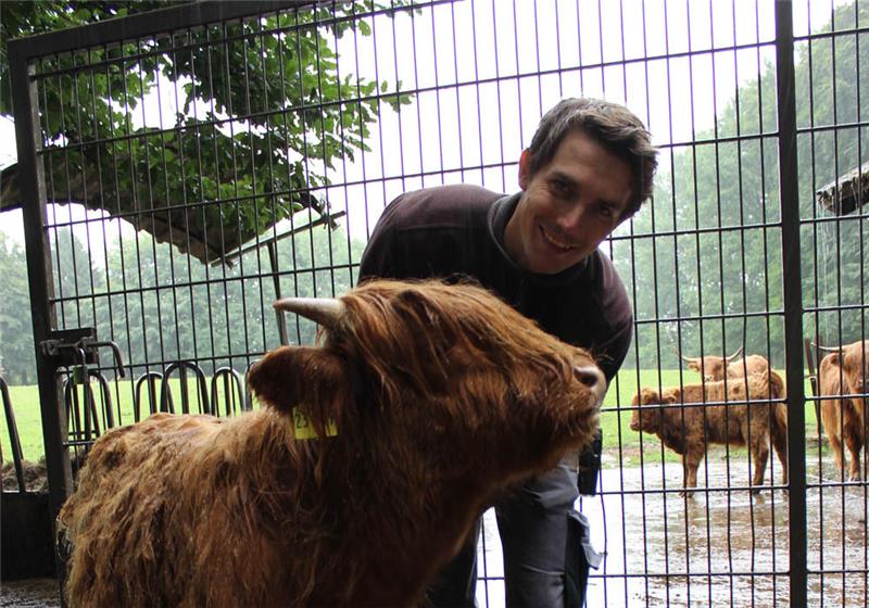 Tierpfleger Sebastian Müller hat das schottische Hochlandrind Lars mit der Hand aufgezogen. Fotos: Nowottny