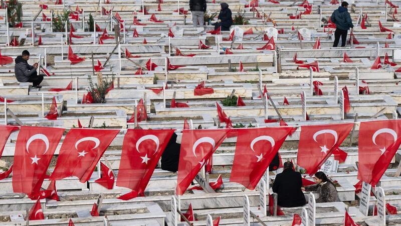 Trauernde besuchen die Gräber von Familienmitgliedern auf einem Friedhof in Antakya.