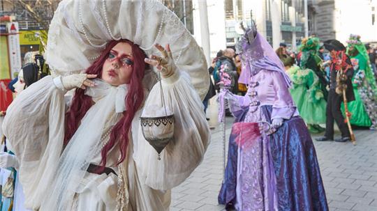 Verkleidete Besucher stehen während des Venezianischen Maskenzaubers in den Colonnaden.