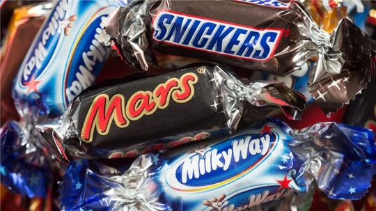 Verschiedene Schokoriegel des Lebensmittelkonzerns Mars liegen auf einem Tisch.