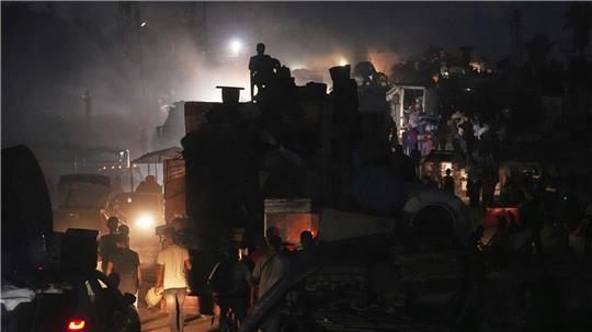 Vertriebene Palästinenser fliehen aus Gaza und tragen ihre Habseligkeiten entlang der Küstenstraße in Richtung des südlichen Gazastreifens.
