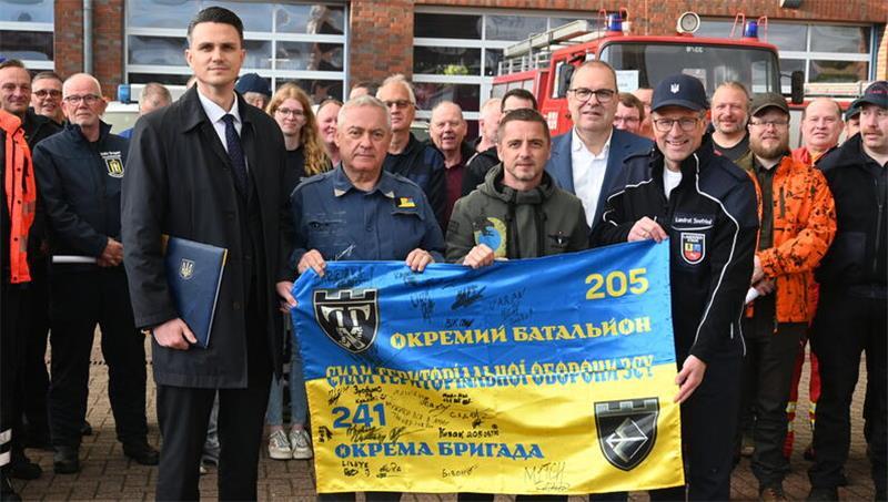Ukraine-Krieg: Wie Hilfe aus dem Kreis Stade Leben retten kann Vizekonsul Boris Drogomyretskyi, Grischa Kaflowsky, Sascha Kaflowsky, Landrat Thorsten Krüger (Cuxhaven) und Landrat Kai Seefried (von links) mit der ukrainischen Flagge.
