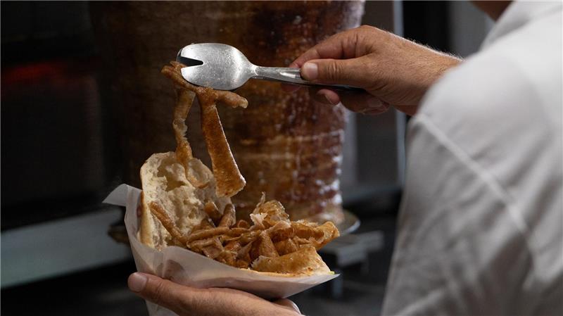 Vom Spieß ins Brot: Ein Mann bereitet einen Döner zu. (Archivbild)