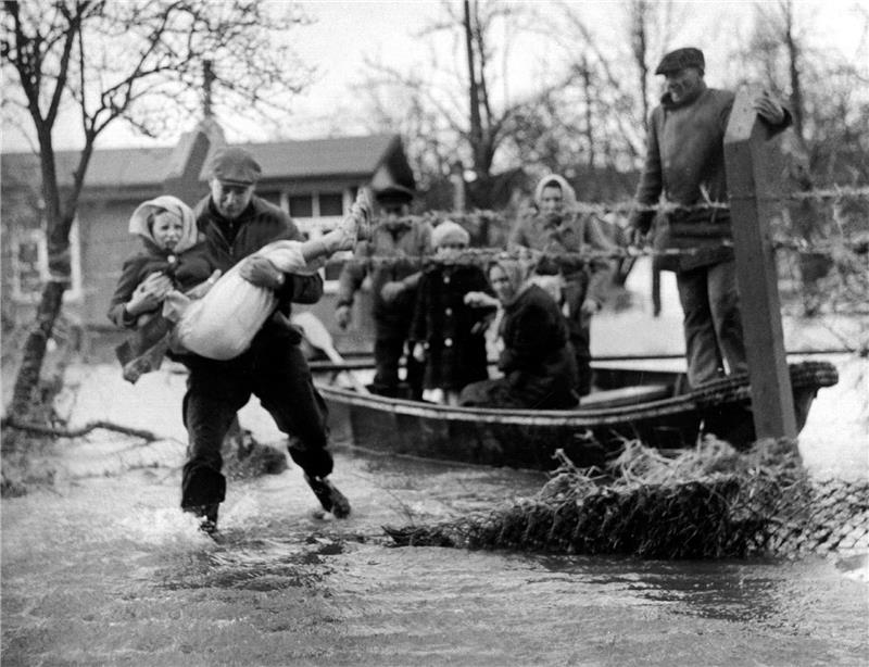 Zeitzeugen erinnern sich an Schrecken und Abenteuer der Sturmflut Vom Wasser eingeschlossene Bewohner des Stadtteils Wilhelmsburg werden mit Booten in Sicherheit gebracht. Im Hamburger Elbgebiet und im norddeutschen Küstenraum verursacht Sturmtief "Vincinette" in der Nacht zum 17. Februar 1962 die bis dahin schwerste Sturmflut des Jahrhunderts in Deutschland. Foto: Lothar Heidtmann/dpa