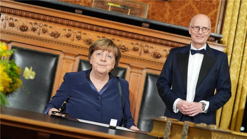 Vor ihrer Rede im Großen Festsaal des Hamburger Rathauses trägt sich Ex-Kanzlerin Angela Merkel (CDU) in das Goldene Buch der Stadt ein.