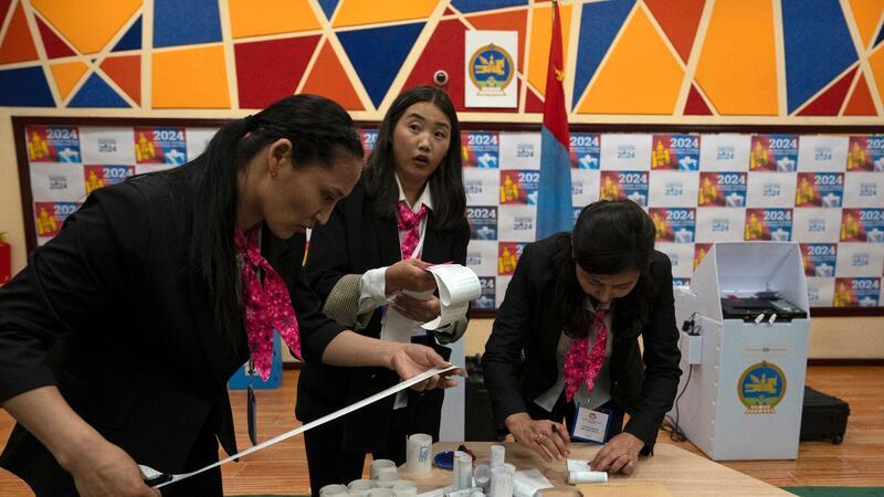 Vorläufige Ergebnisse: Mongolische Volkspartei gewinnt Wahl Wahlhelfer überprüfen die Ausdrucke der Ergebnisse von den Stimmauszählungsmaschinen nach Schließung der Wahllokale.