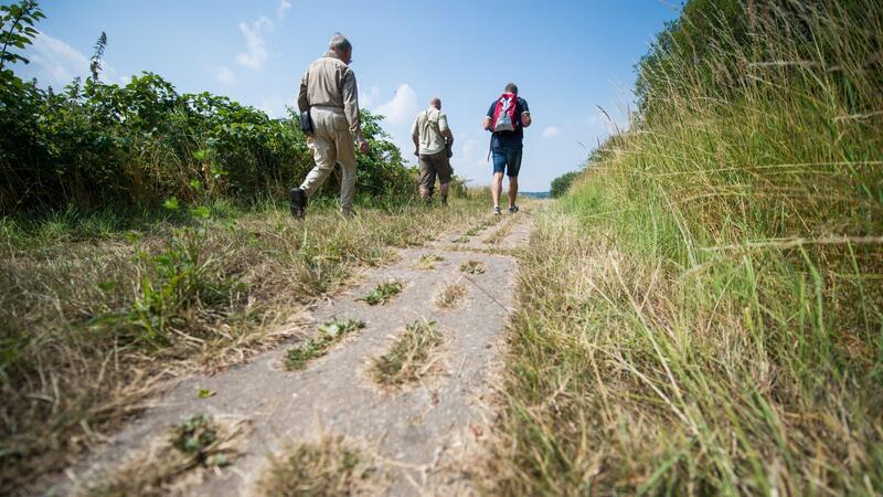 Wanderer laufen am ehemaligen innerdeutschen Grenzstreifen entlang.