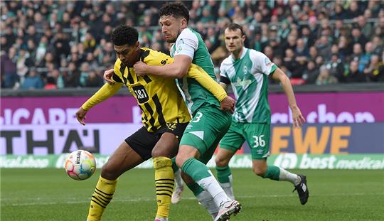 Werders Milos Veljkovic (r) kämpft gegen Dortmunds Jude Bellingham um den Ball. Foto: Carmen Jaspersen/dpa