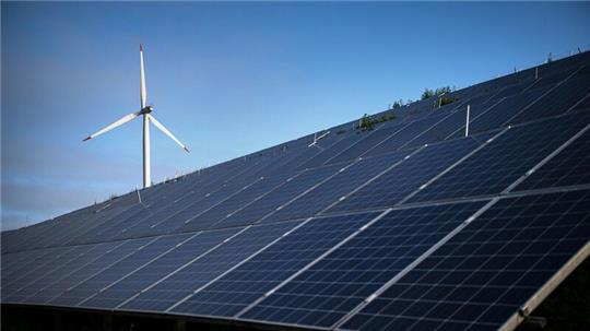 Windkraftanlagen stehen hinter Photovoltaikanlagen auf der Blocklanddeponie.