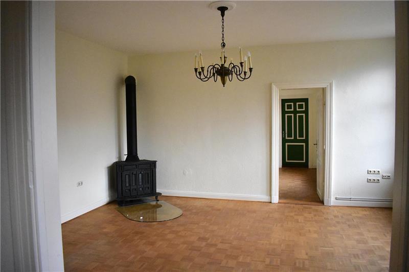 Ein Raum mit einem Kamin und Kornleuchter im Pfarrhaus in Balje.