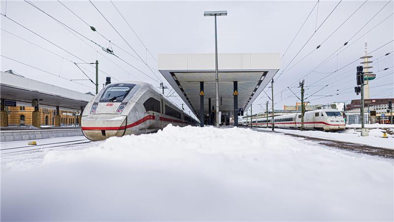 Zwei ICE stehen im verschneiten Hauptbahnhof Hannover.