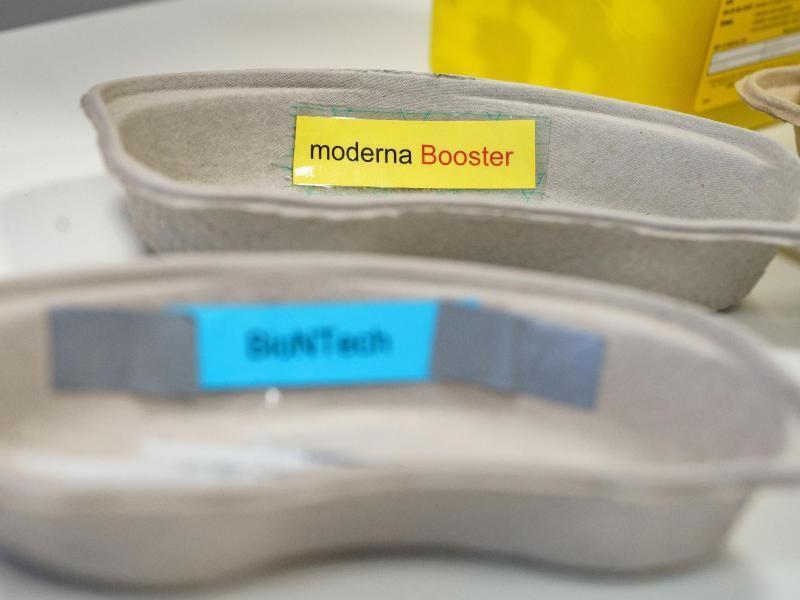 Zwei Schalen mit Booster-Impfstoff von Moderna und dem normalen Impfstoff von Biontech/Pfizer liegen bereit. Foto: Frank Rumpenhorst/dpa