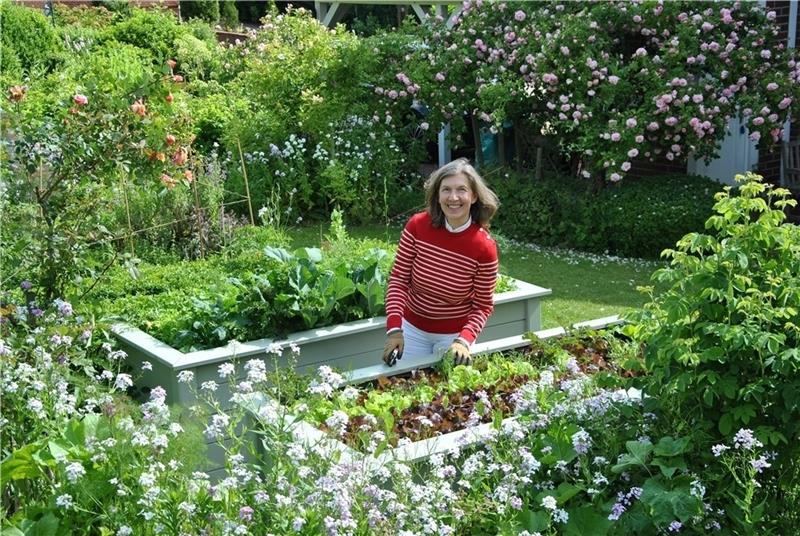 Zwischen blühenden Pflanzen und Hochbeeten mit Salat, Gemüse und Kräutern: Lucia Baumgärtner in ihrem Garten in Nottensdorf. Fotos: Lohmann